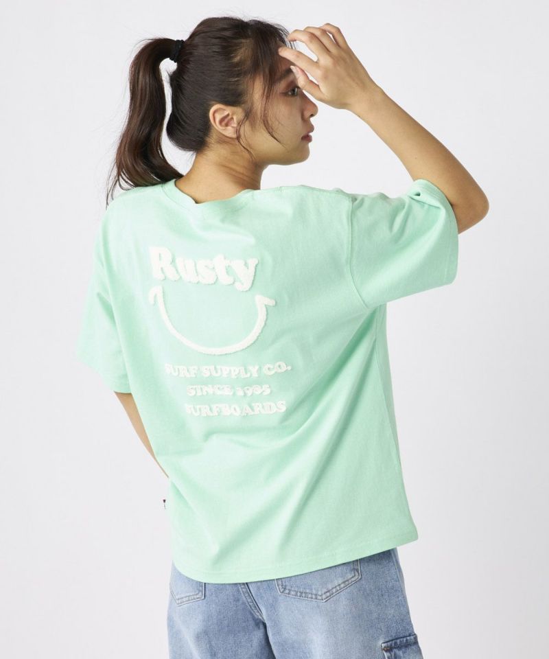 RUSTYレディース ニコちゃん相良刺繍Tシャツ 襟ワンポイント